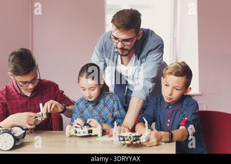 Students Learn About Robotics Skills in a Classroom Environment With Hands-On Activities Stock Photo