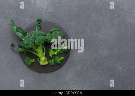 Fresh Broccoli Arranged on a Dark Surface for Healthy Cooking and Meal Preparation Stock Photo