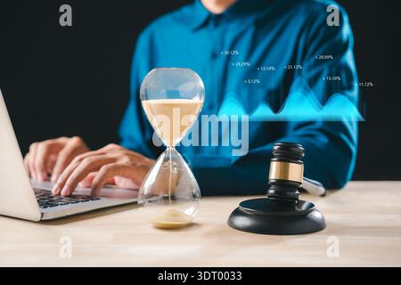 Hourglass, legal gavel, clock timer, time deadline, justice concept, professional working laptop, managing critical law matters, analyzing financial g Stock Photo