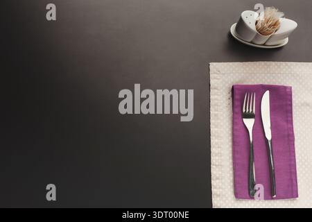 Dining Set Arranged Neatly on a Table With Utensils and a Small Condiment Holder Stock Photo