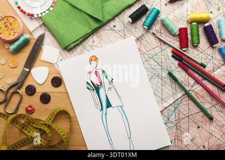 Fashion Design Collection Displayed on a Workspace With Sewing Tools and Materials Stock Photo