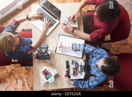 Group of Students Working on Robotics Project in a Classroom Setting During the Day Stock Photo