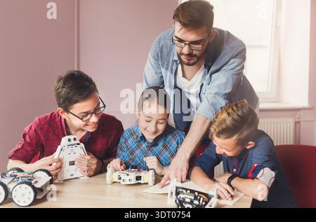 Students Learn About Robotics and Coding in a Classroom Setting With a Teacher Present Stock Photo