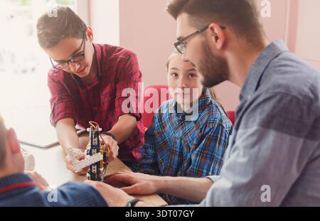 Students Work Together on a Robotics Project at an Educational Center in a Classroom Setting Stock Photo