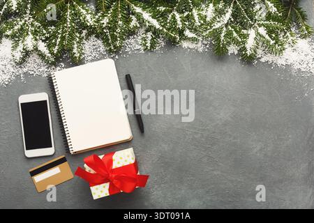 Creative Workspace Setup for Holiday Planning With Notebook and Smartphone on Grey Surface Stock Photo