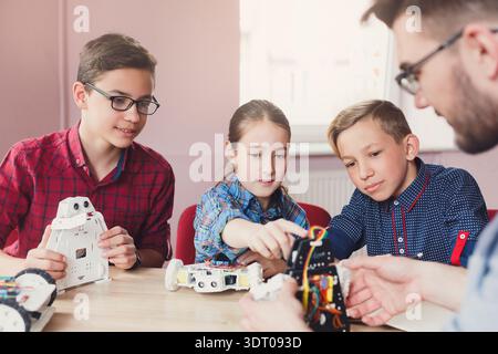 Students Learn Coding and Robotics Skills in a Workshop Setting in a Classroom Environment Stock Photo