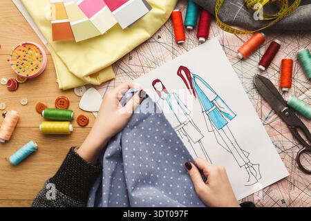 Creative Process of Fashion Design With Fabric and Sketches in a Workspace Stock Photo