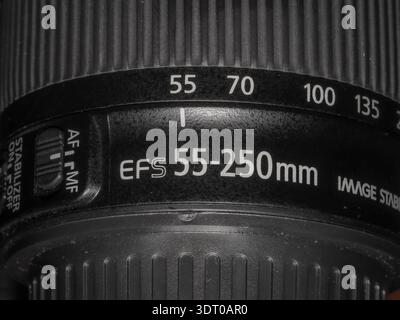 Close-up of Canon EF-S 55–250mm lens showing zoom markings and autofocus switch under studio lighting Stock Photo