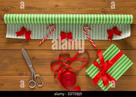 Collage of Gift Wrapping Materials and Tools on a Wooden Table During the Holiday Season Stock Photo