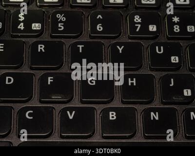Close-up of black computer keyboard showing letter and number keys in rows, symbolizing technology, communication, and typing Stock Photo