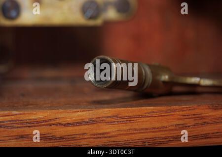 Close-up of an antique skeleton key resting on wooden surface, symbolizing history, craftsmanship, and unlocking possibilities Stock Photo