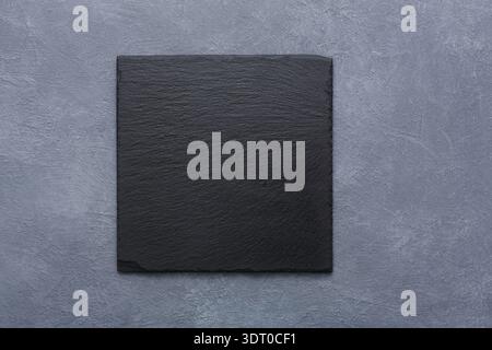 Dark Slate Stone Tile on a Textured Gray Background for Design or Decor Use in Various Settings Stock Photo