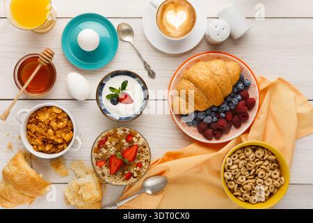 Variety of Breakfast Foods Arranged in a Beautiful Collage on a Wooden Table Stock Photo