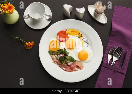 Delicious Breakfast Collection With Eggs, Vegetables, and Sides on a Table Setting Stock Photo