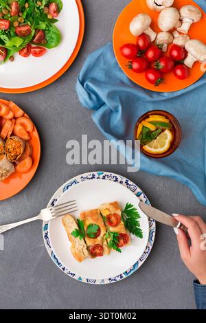 Different Dishes Are Served on Colorful Plates for a Meal With Friends at Home Stock Photo