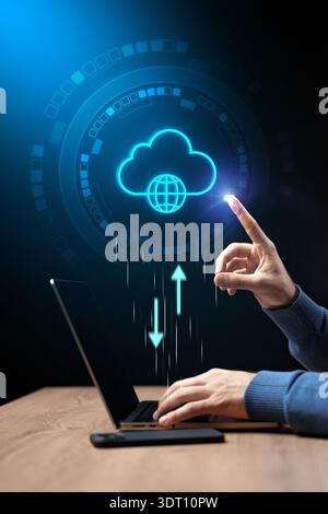 Person using laptop to upload data to cloud storage in digital workspace Stock Photo