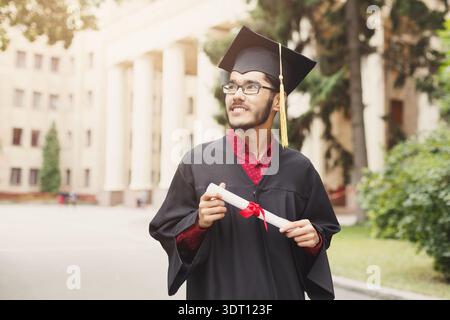 Graduation Celebration at the University Campus With a Proud Graduate Holding a Diploma Stock Photo