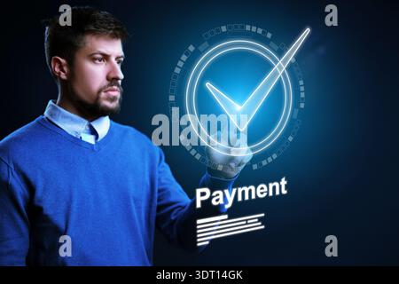 Man conducts banking invoice payment using digital technology in a modern setting Stock Photo
