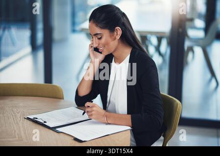 Phone call, smile and documents with business woman in office for networking, schedule manager and contact. Communication, planning and conversation Stock Photo
