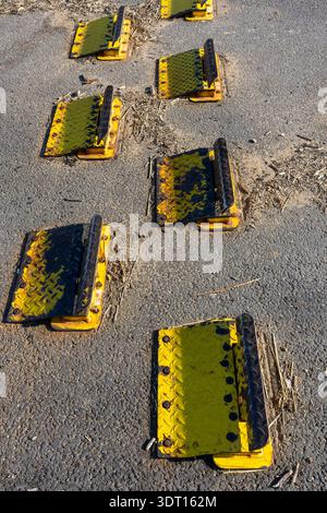 One way yellow traffic spikes on asphalt Stock Photo