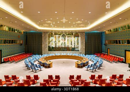 The Security Council Chamber shows rows of colored chairs and a large mural. The setting reflects an important venue in global diplomacy. Stock Photo