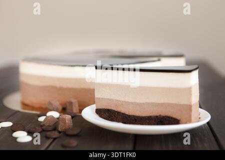 Dessert Display With Layered Cake and Chocolate Pieces on Wooden Table Stock Photo