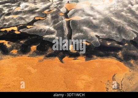 Aerial view depicting the contrasting hues of a saline landscape in the province of Toledo, Spain, showcasing unique formations and textures created b Stock Photo