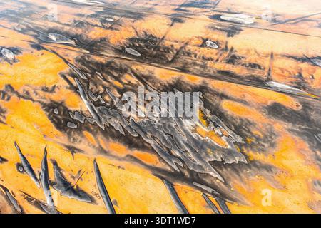 Aerial view of striking saline formations in the province of Toledo, Spain, displaying vivid orange and black textures. The natural patterns create a Stock Photo