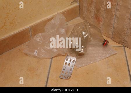 Littered plastic bottle, blister pack, and bags showing environmental trash Stock Photo