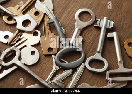 Key Collage That Shows Various Types of Keys on a Wooden Surface in a Collection of Shapes and Sizes Stock Photo