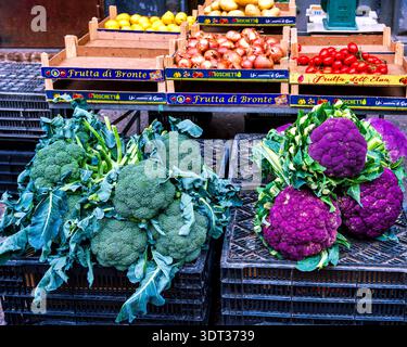 Green and purple broccoli at a market stall in Catania, Sicily, Italy Stock Photo