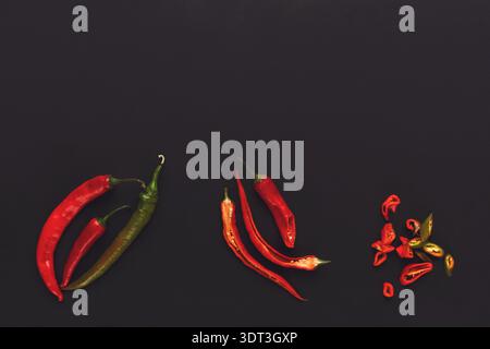 Collection of Different Types of Peppers Arranged on a Dark Background in a Creative Collage Stock Photo