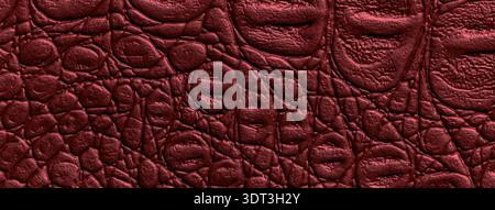 Dark red wine leather texture background. Burgundy embossed crocodile skin textile surface macro. Stock Photo