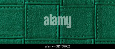 Texture dark emerald leather background with quilted stitched pattern, macro. Abstract deep green upholstery surface. Stock Photo