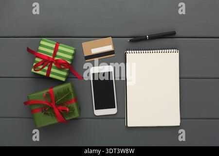 Gift Preparation Scene With Presents and Note-Taking Tools on a Wooden Table Stock Photo