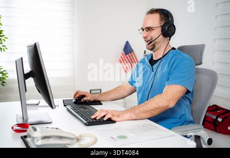 Male medical professional working in call center wearing headset Stock Photo
