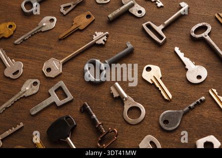 Collection of Vintage Keys Arranged on a Wooden Background in a Unique Collage Setting Stock Photo