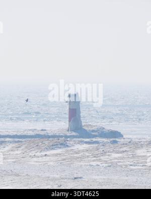 channel marker on frozen lake michigan Stock Photo