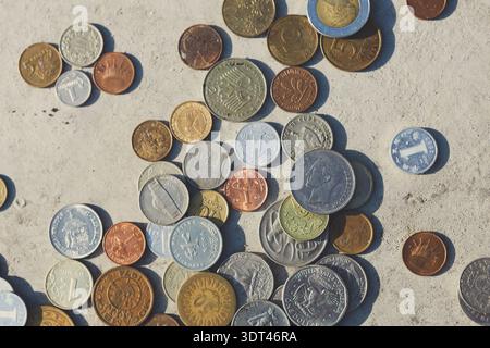 Coins Arranged in a Collage Showing Different Countries Over Time in a Collection Stock Photo
