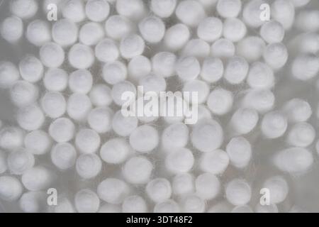 Close up cotton swabs forming abstract circular pattern, repeating soft spheres create minimalist texture and artistic background suitable for design Stock Photo