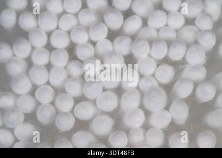 Close up cotton swabs used for cleaning electronics, dense cotton tips shown against mesh background, evokes precision maintenance and delicate dust r Stock Photo