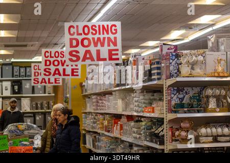 LONDON - 8 DECEMBER 2025: Kilburn High Road NW6 – Closing Down Sale Interior, Discount Homeware Store with Hanging Signs Stock Photo