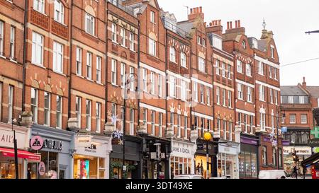 LONDON - 15 DECEMBER 2025: Hampstead High Street NW3 – Ornate Victorian Brick Buildings & Holiday Decor Stock Photo