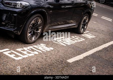 Electric Vehicles Only Parking Bay – Luxury EV Parked on Reserved Urban Charging Spot Concept Stock Photo