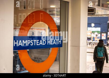 LONDON - DECEMBER 15, 2025: Hampstead Heath Overground station roundel entrance sign Mildmay line Stock Photo