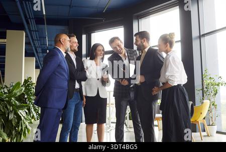 Business team meeting in modern open plan office, colleagues discussing strategy Stock Photo