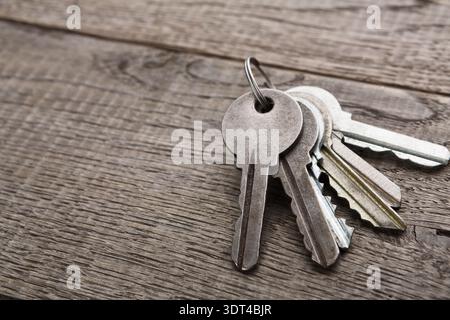 Collection of Keys on a Wooden Surface With a Focus on the Textures and Colors of Different Metals Stock Photo