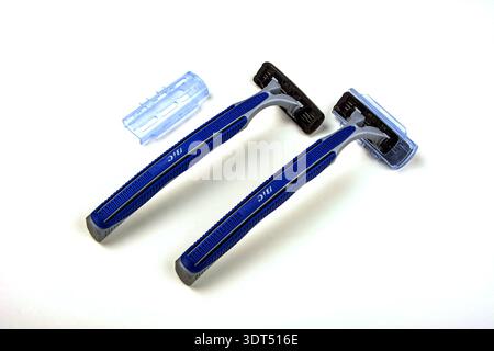 Lviv, Ukraine. April 13, 2025.Razor for shaving on white background.Two blue Razors in white background. Stock Photo