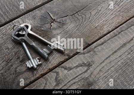 Collection of Keys Arranged on a Wooden Surface in a Layered Pattern Stock Photo