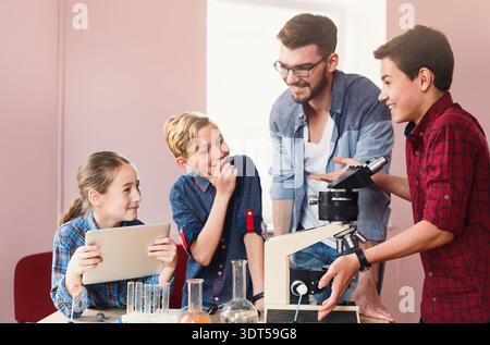 Students Learn About Science Through Hands-On Activities With a Teacher in a Classroom Setting Stock Photo